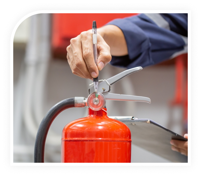 Technician inspecting a fire extinguisher